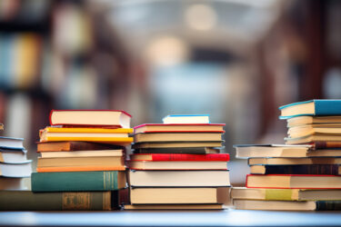 stacks of book on a table at the library