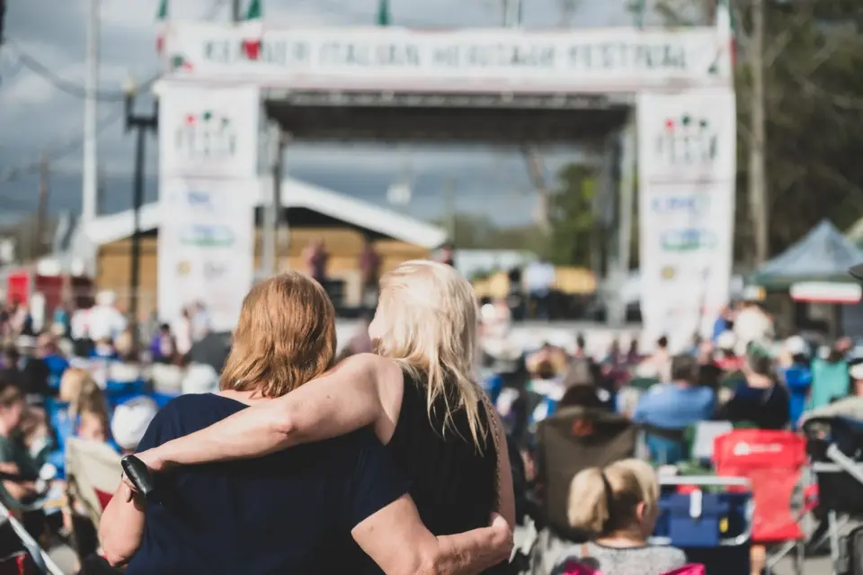 family with arms around each other at the Kenner Italian Festival